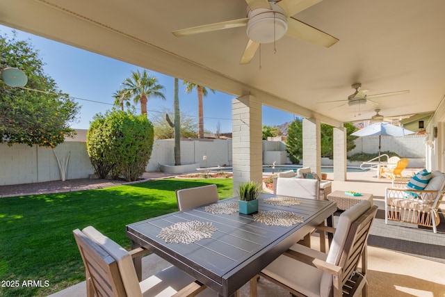 view of patio / terrace with ceiling fan and a fenced in pool