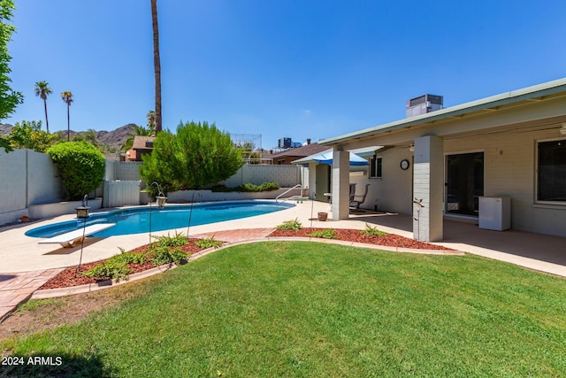 view of pool with a lawn, a diving board, and a patio area