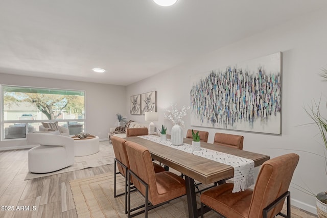 dining space with light hardwood / wood-style floors