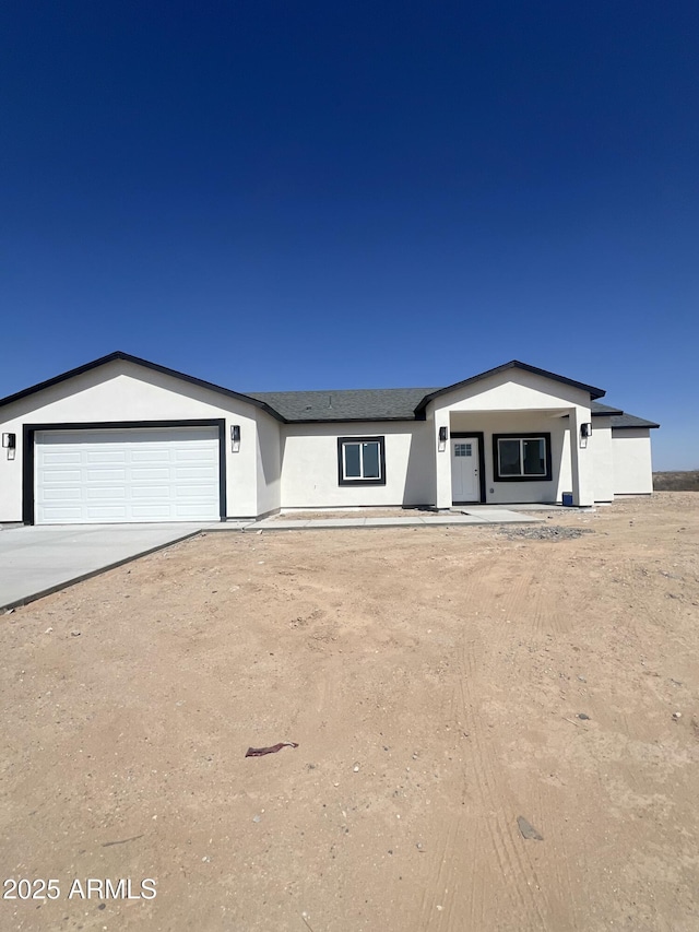 3755 N 363rd Ave, Tonopah, AZ 85354 - view of front of house with a garage, stucco siding, and concrete driveway