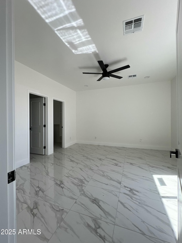 3755 N 363rd Ave, Tonopah, AZ 85354 - spare room with a ceiling fan, marble look tiles, and baseboards