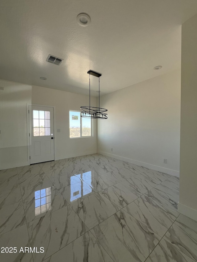 3755 N 363rd Ave, Tonopah, AZ 85354 - spare room featuring light marble finish floors, baseboards, and a chandelier