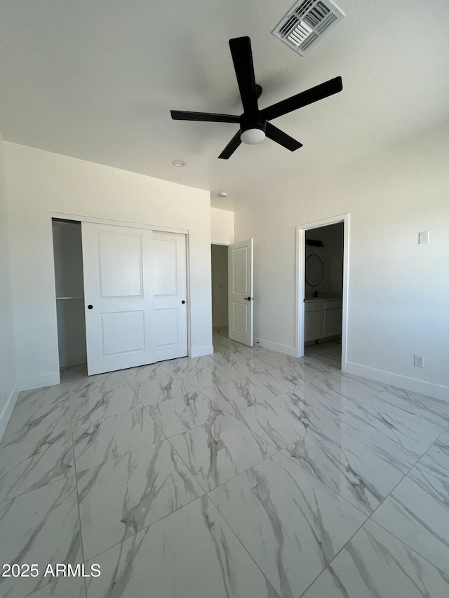 3755 N 363rd Ave, Tonopah, AZ 85354 - unfurnished bedroom with baseboards, a closet, ceiling fan, and light marble finish floors
