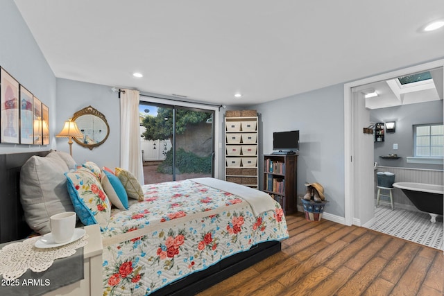 bedroom with hardwood / wood-style floors and access to outside