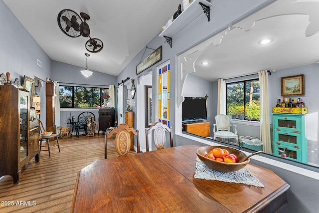 dining space with hardwood / wood-style floors and lofted ceiling