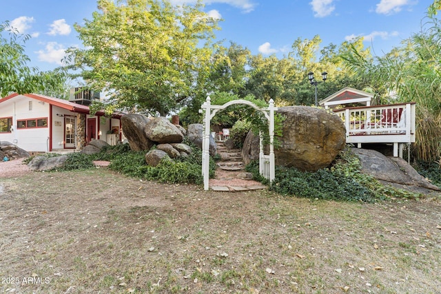 view of yard with a wooden deck and a garage