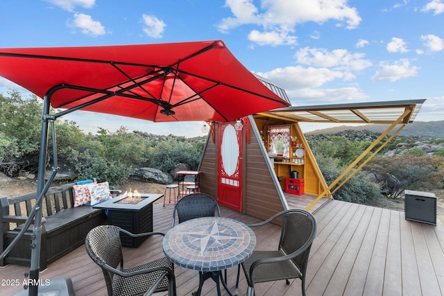 wooden deck featuring an outdoor fire pit