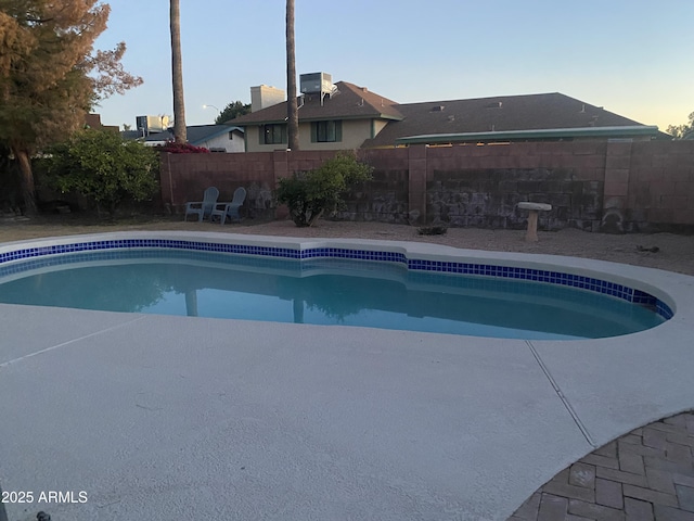 view of pool at dusk