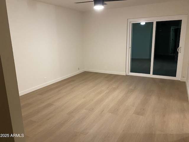 empty room with ceiling fan and light hardwood / wood-style floors