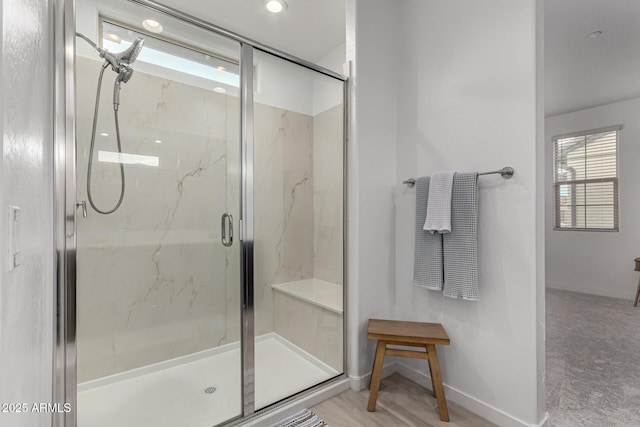 bathroom featuring a shower with door