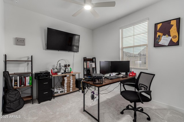 carpeted office space featuring ceiling fan