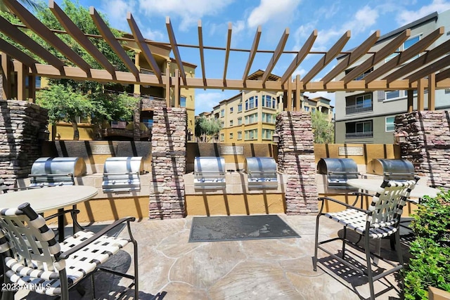 view of patio featuring an outdoor kitchen, a pergola, and area for grilling