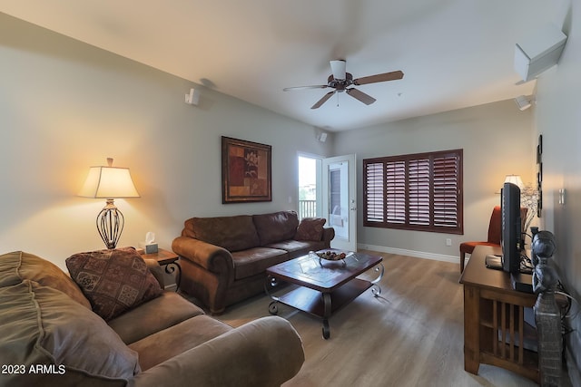 living room with light hardwood / wood-style floors and ceiling fan