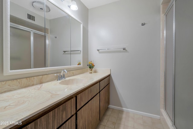 full bath featuring baseboards, visible vents, an enclosed shower, and vanity