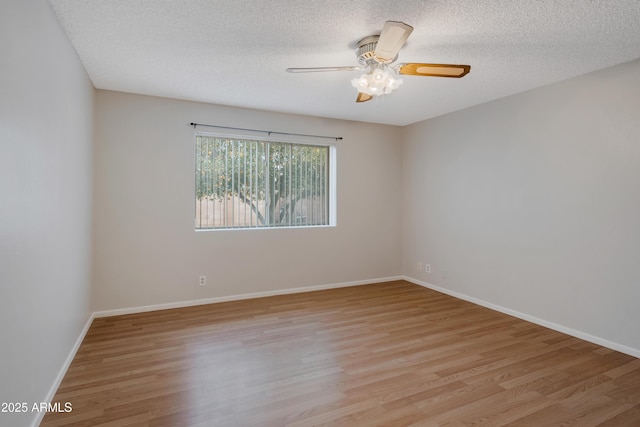 unfurnished room with light wood-style floors and a textured ceiling