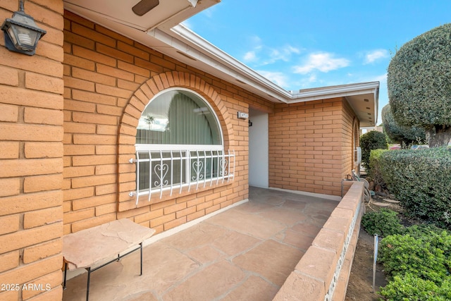 doorway to property with brick siding