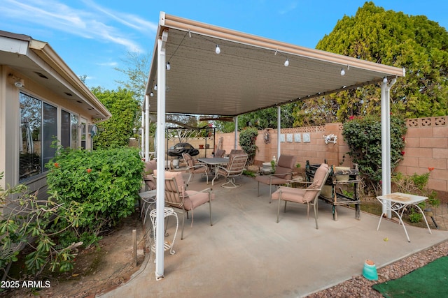 view of patio featuring outdoor dining space and a fenced backyard