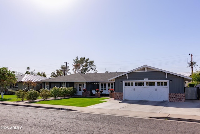 view of front of house featuring brick siding, an attached garage, board and batten siding, driveway, and a front lawn