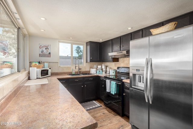2843 E Captain Dreyfus Ave, Phoenix, AZ 85032 - kitchen featuring stainless steel refrigerator with ice dispenser, electric range, under cabinet range hood, white microwave, and light countertops