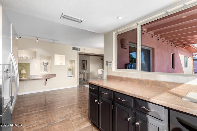 2843 E Captain Dreyfus Ave, Phoenix, AZ 85032 - kitchen featuring rail lighting, wood finished floors, stainless steel fridge, and light countertops
