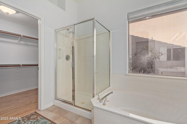 bathroom with tile patterned floors and separate shower and tub