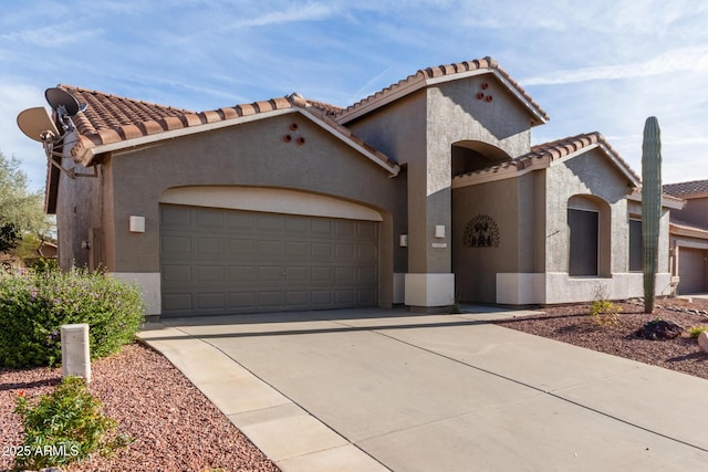 mediterranean / spanish-style house with a garage