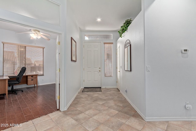 foyer entrance with light hardwood / wood-style floors and ceiling fan