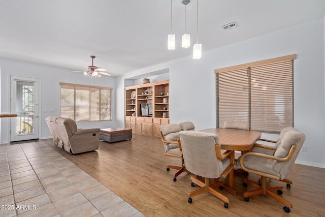 dining room with ceiling fan and light hardwood / wood-style floors