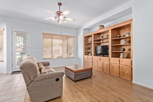 living room with light hardwood / wood-style flooring and ceiling fan