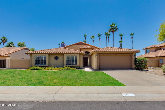 5507 E Kings Ave, Scottsdale, AZ 85254 - mediterranean / spanish-style house with stucco siding, an attached garage, concrete driveway, and a tile roof