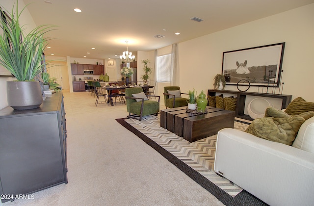 living room with a chandelier and light carpet