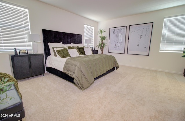 bedroom featuring light colored carpet