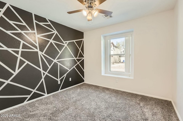 carpeted empty room featuring ceiling fan, visible vents, and baseboards