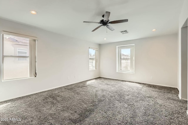 empty room featuring baseboards, visible vents, carpet flooring, and recessed lighting