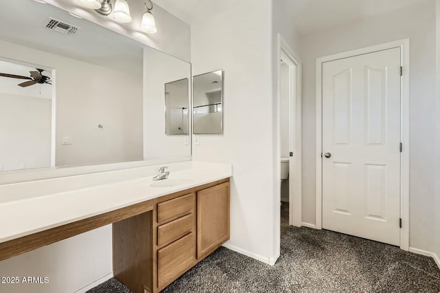 bathroom featuring baseboards, visible vents, a ceiling fan, toilet, and vanity