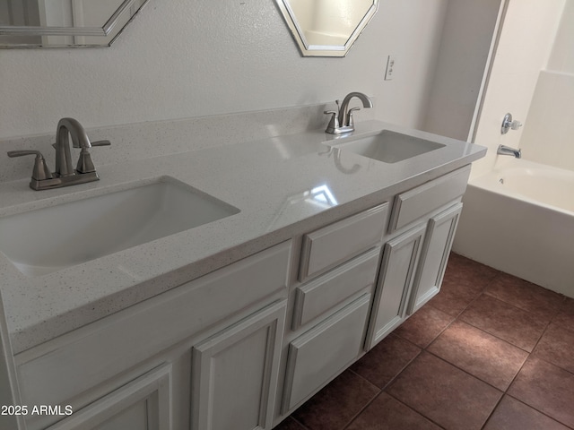 bathroom with tile patterned flooring, a sink, bathing tub / shower combination, and double vanity