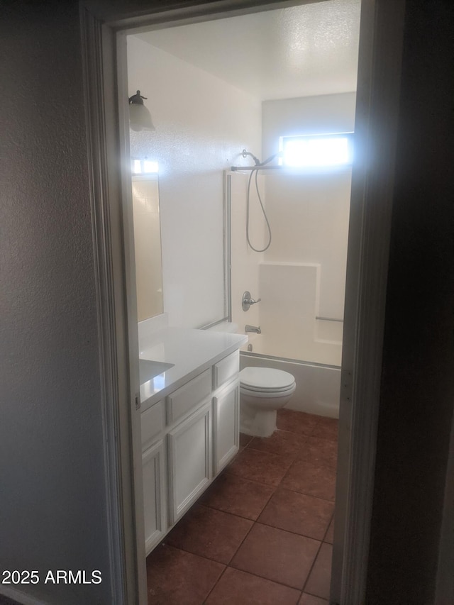 bathroom with bathtub / shower combination, vanity, toilet, and tile patterned floors