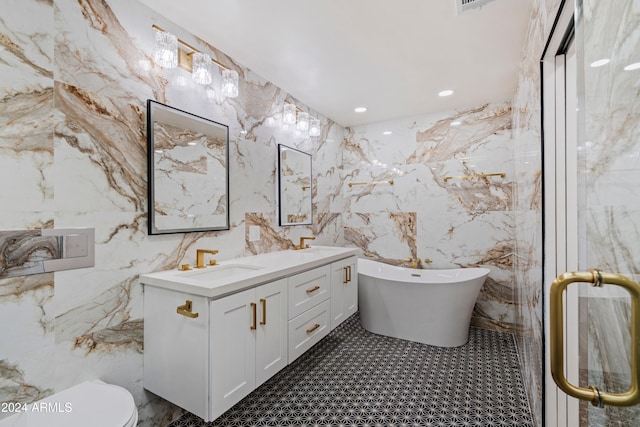 bathroom featuring toilet, vanity, and a bath