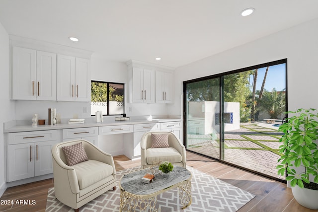 kitchen featuring wood-type flooring and white cabinets