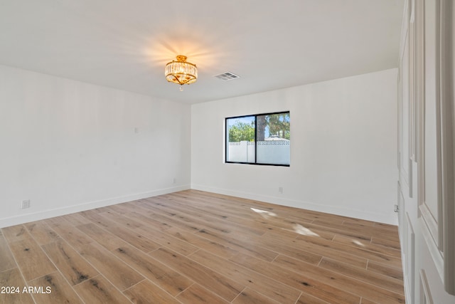 empty room with light hardwood / wood-style flooring