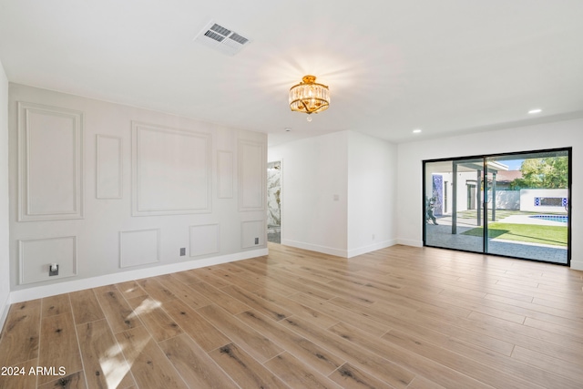 spare room featuring light hardwood / wood-style flooring