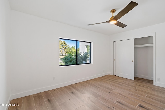 unfurnished bedroom with a closet, ceiling fan, and light wood-type flooring