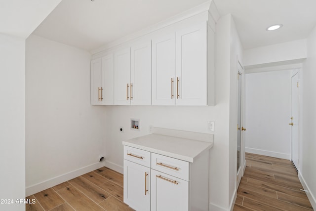 laundry area with cabinets, washer hookup, hookup for an electric dryer, and light hardwood / wood-style floors