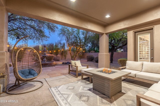 view of patio / terrace featuring an outdoor living space with a fire pit