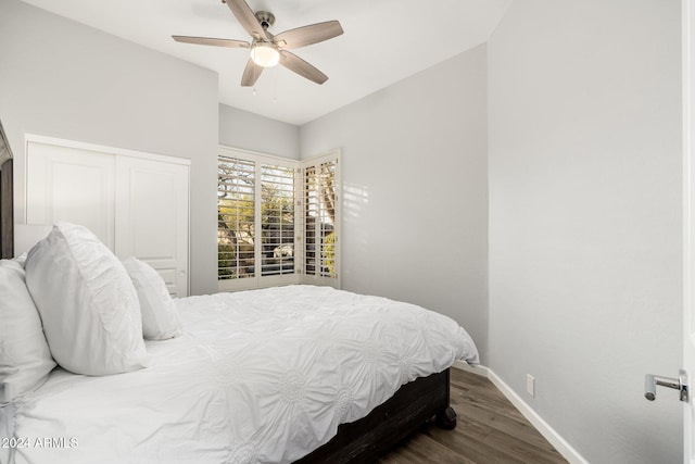 bedroom with a closet, ceiling fan, and dark hardwood / wood-style floors