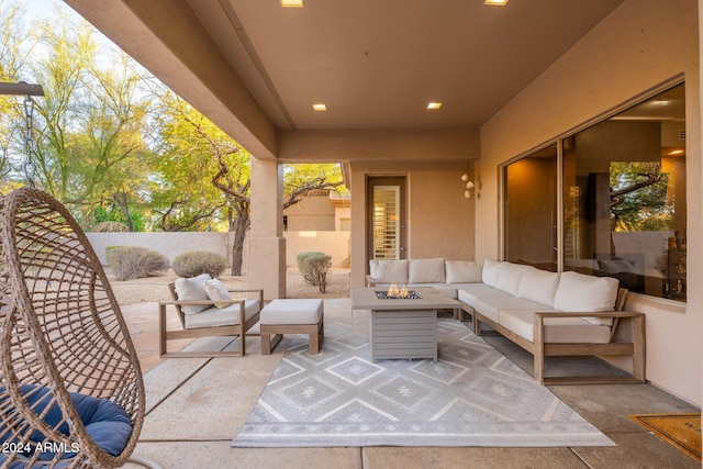 view of patio / terrace with an outdoor living space with a fire pit