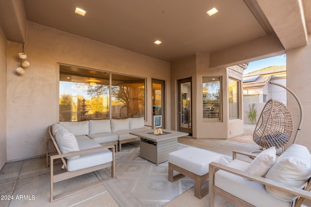 view of patio / terrace with an outdoor living space with a fire pit