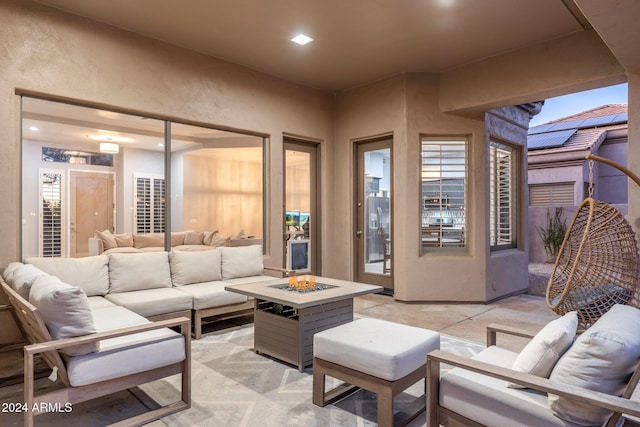 view of patio with an outdoor living space with a fire pit