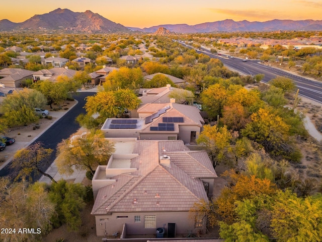 aerial view at dusk featuring a mountain view