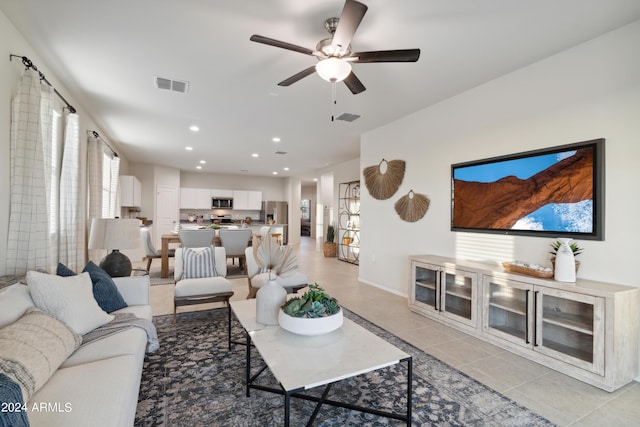 living room featuring light tile patterned flooring and ceiling fan